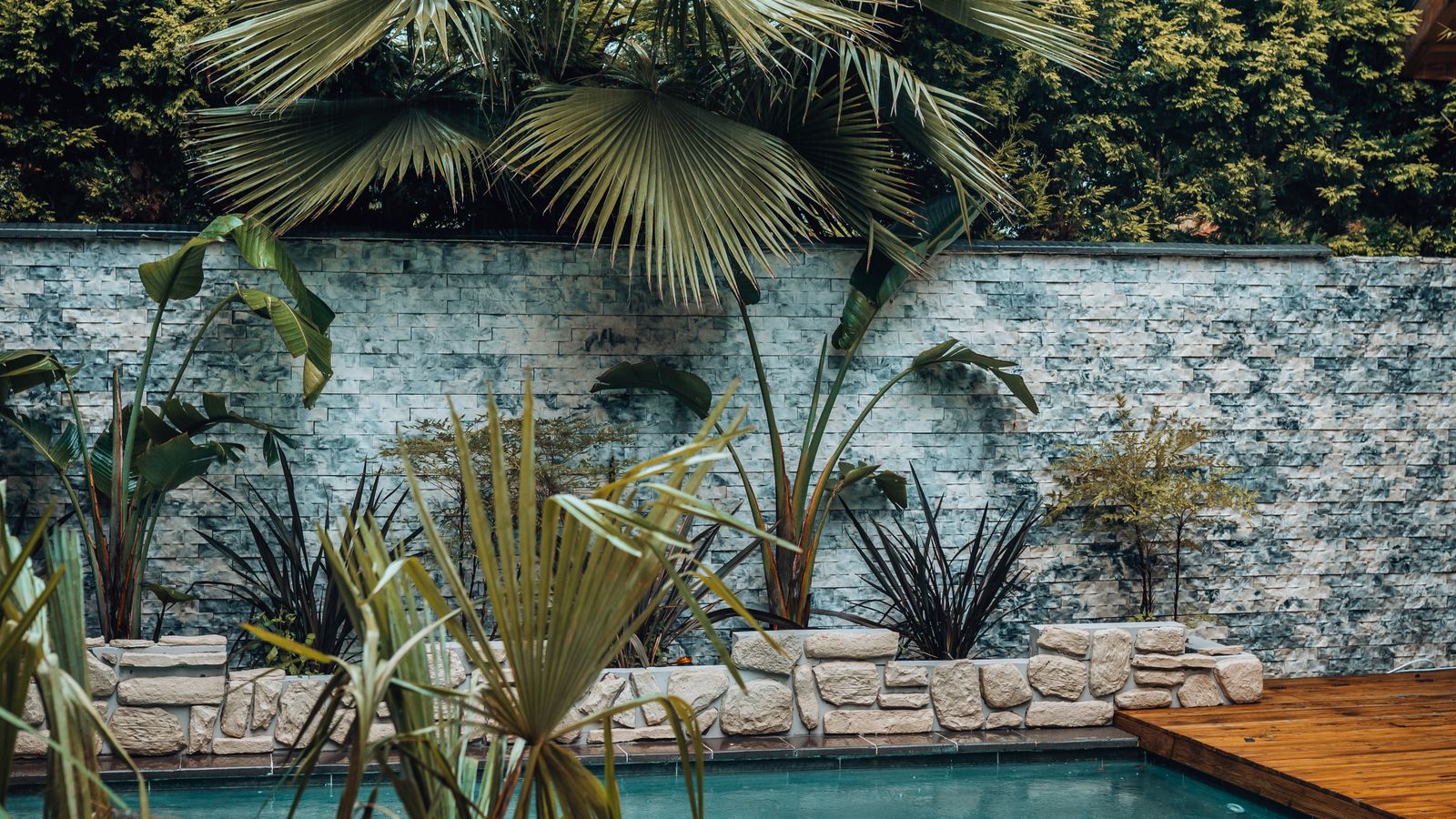 Luxury pool deck with tropical landscaping representative of Pinecrest large-lot residential projects