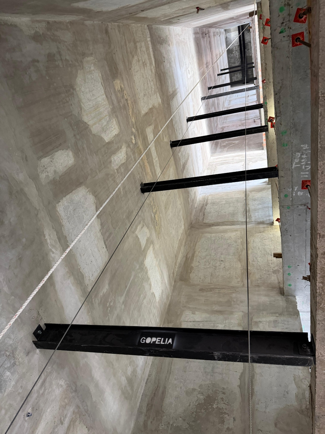 GOPELIA-branded elevator hoist beam installed in the concrete shaft at 626 Flagler