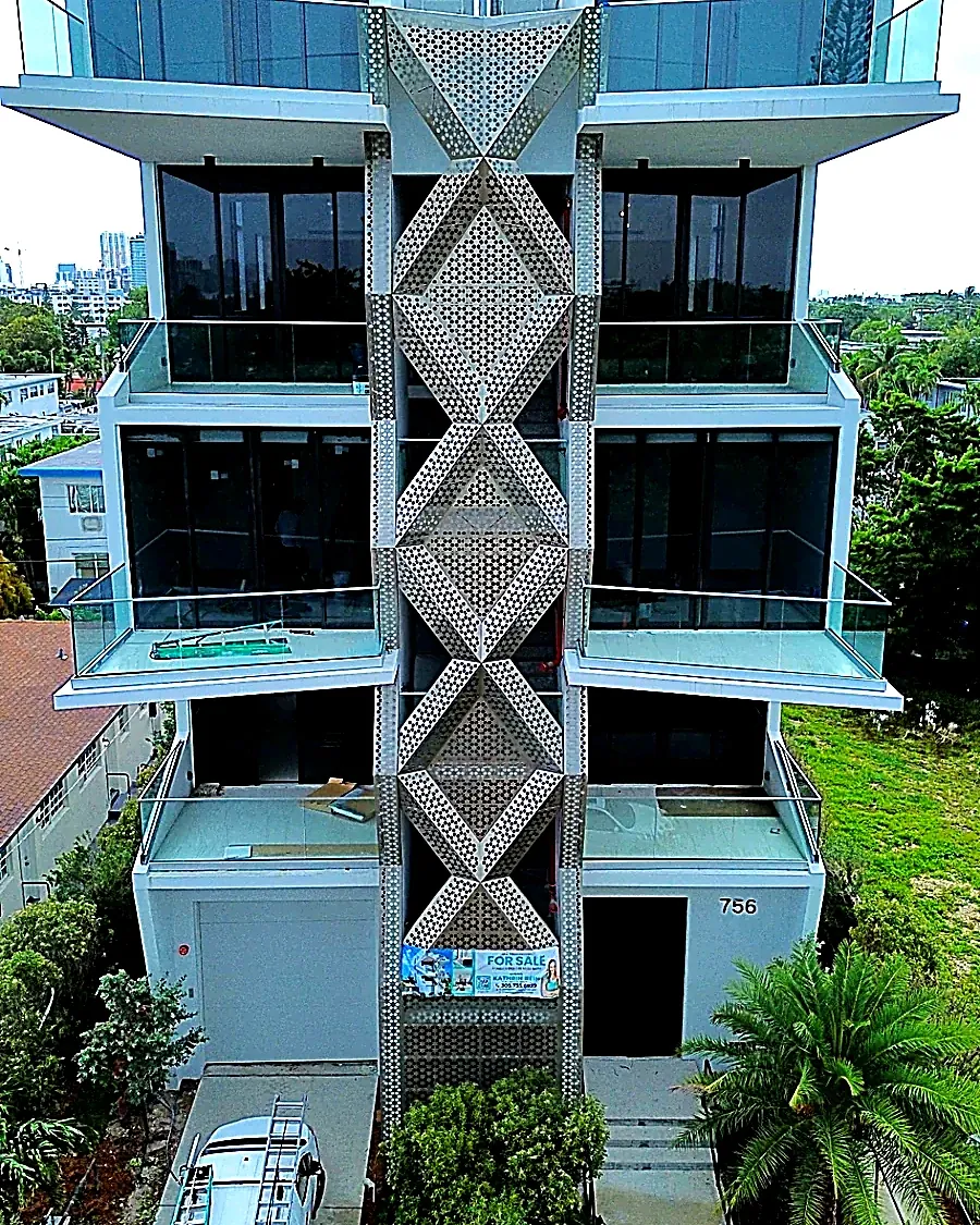 Custom perforated aluminum diamond screen facade - 756 84 St Residences, Miami Beach FL