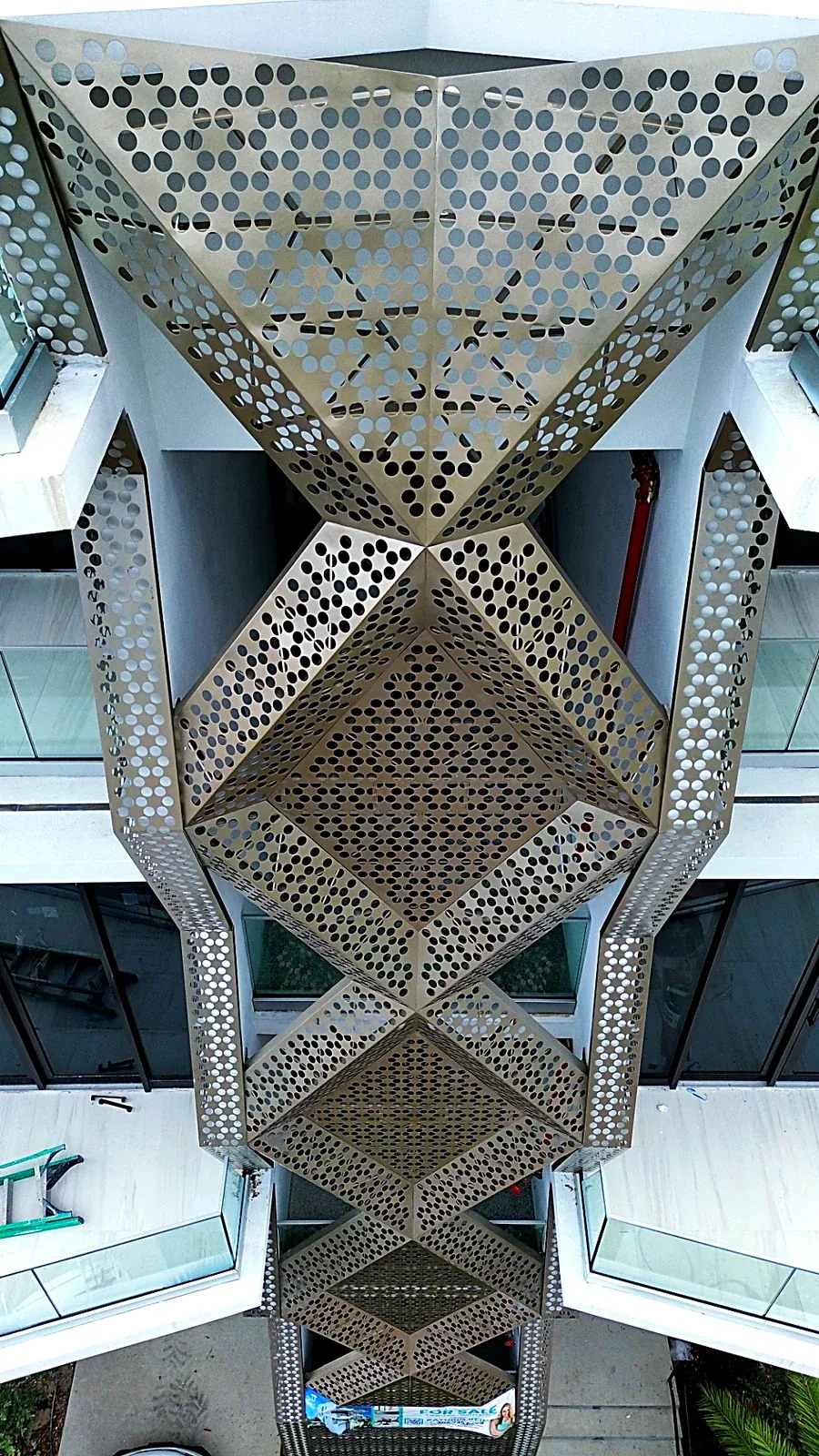 Faceted perforated aluminum screen underside view - 756 84 St Residences, Miami Beach FL