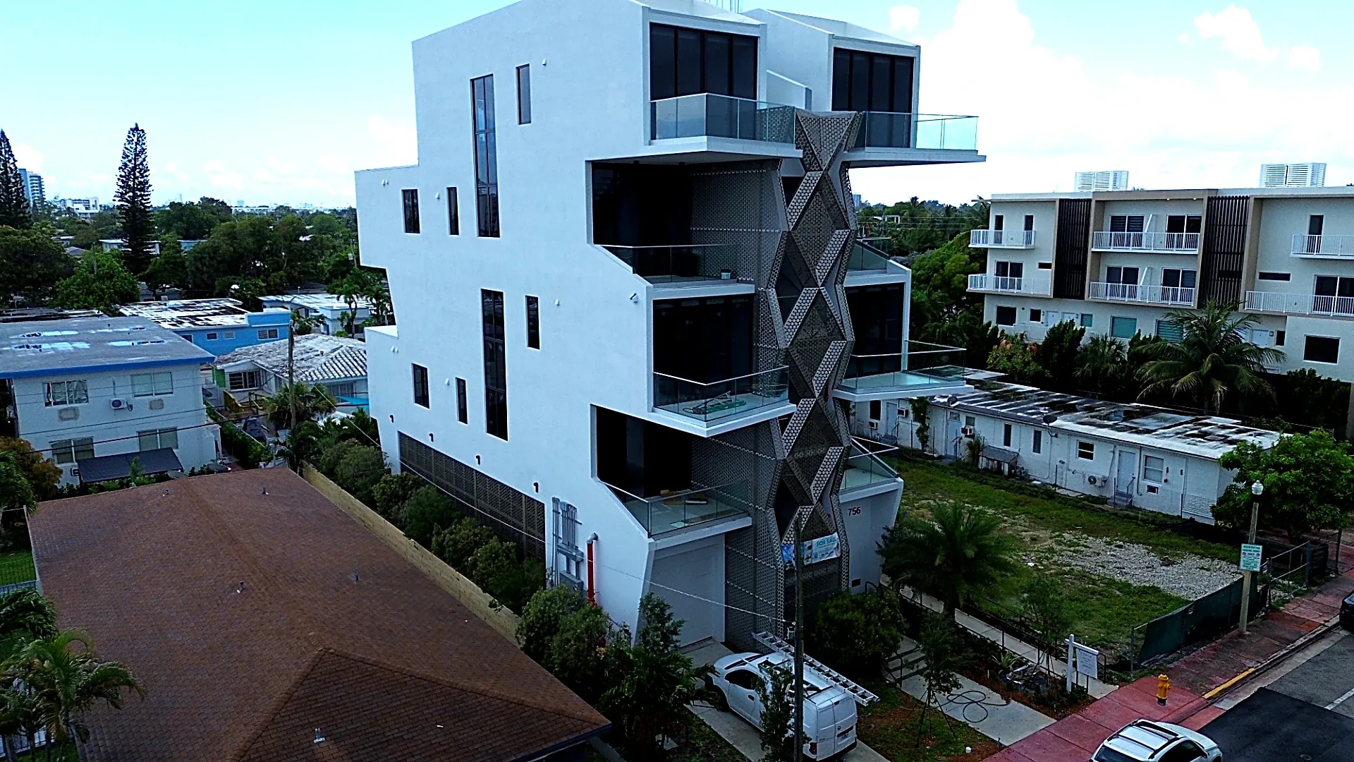 Perforated aluminum diamond screen facade, aerial view - 756 84 St Residences, Miami Beach FL