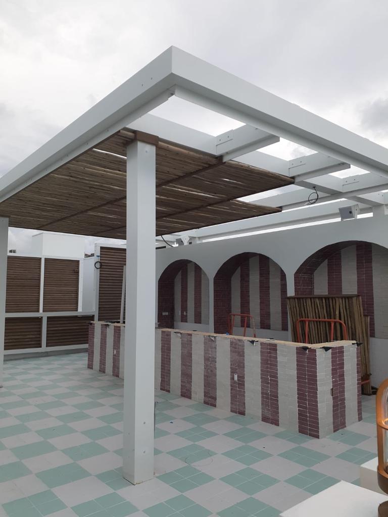 Rooftop pergola with metal frame and natural bamboo cladding — Esme Hotel, Miami Beach FL