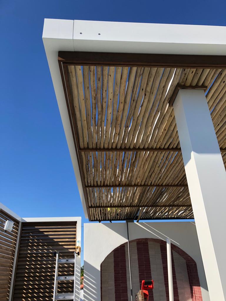 Pergola detail with decorative louver screens and bamboo canopy — Esme Hotel, Miami Beach FL