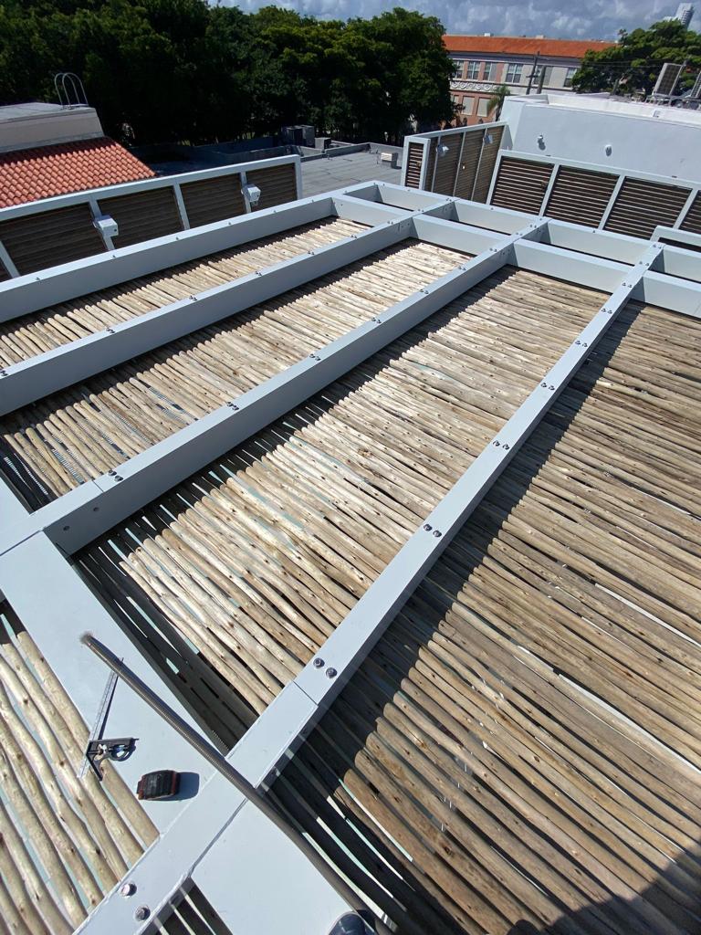 Aerial view of rooftop pergola structure with metal beams and natural roof — Esme Hotel, Miami Beach FL
