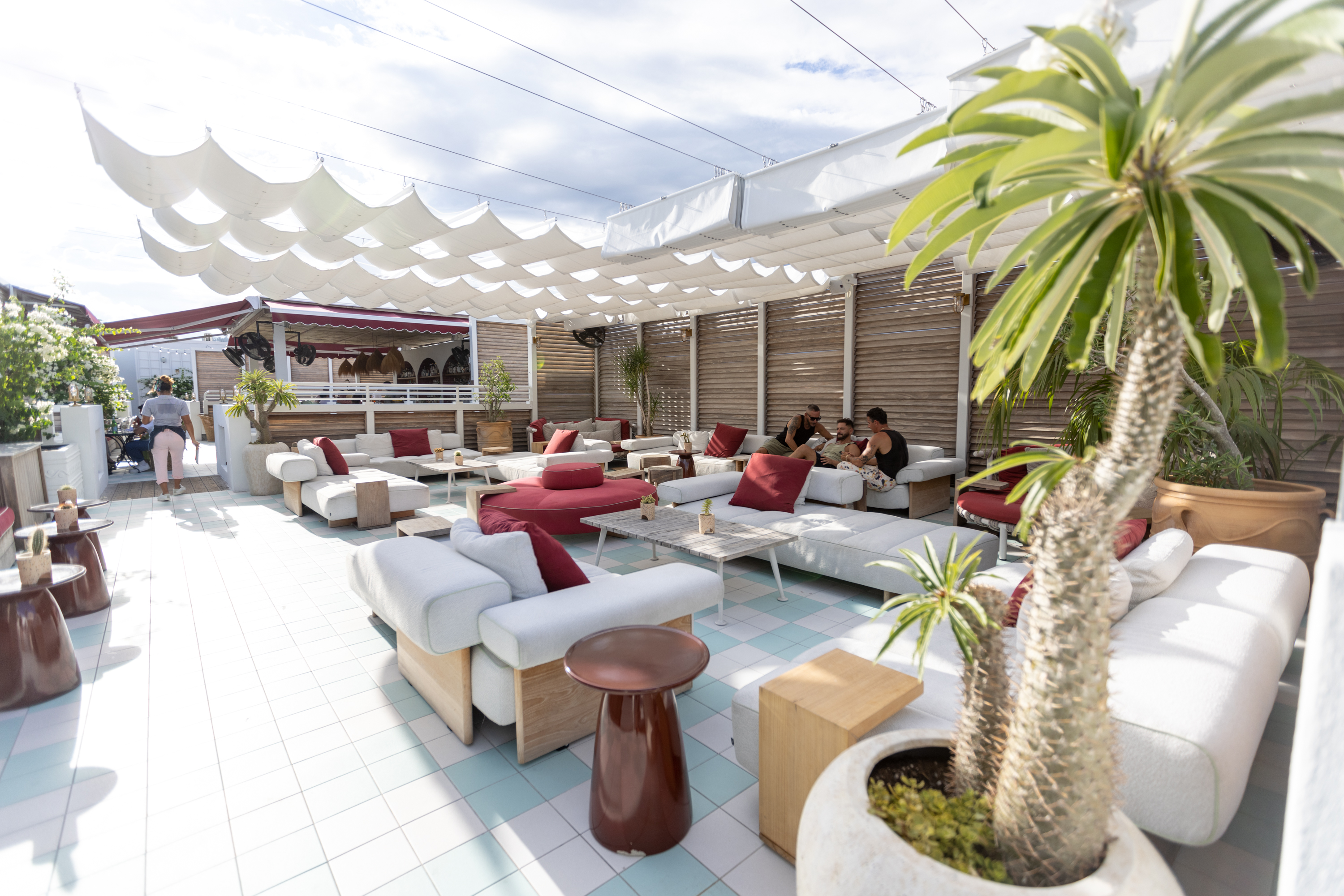 Rooftop seating area with pergola, louver screens, and tropical plants — Esme Hotel, Miami Beach FL