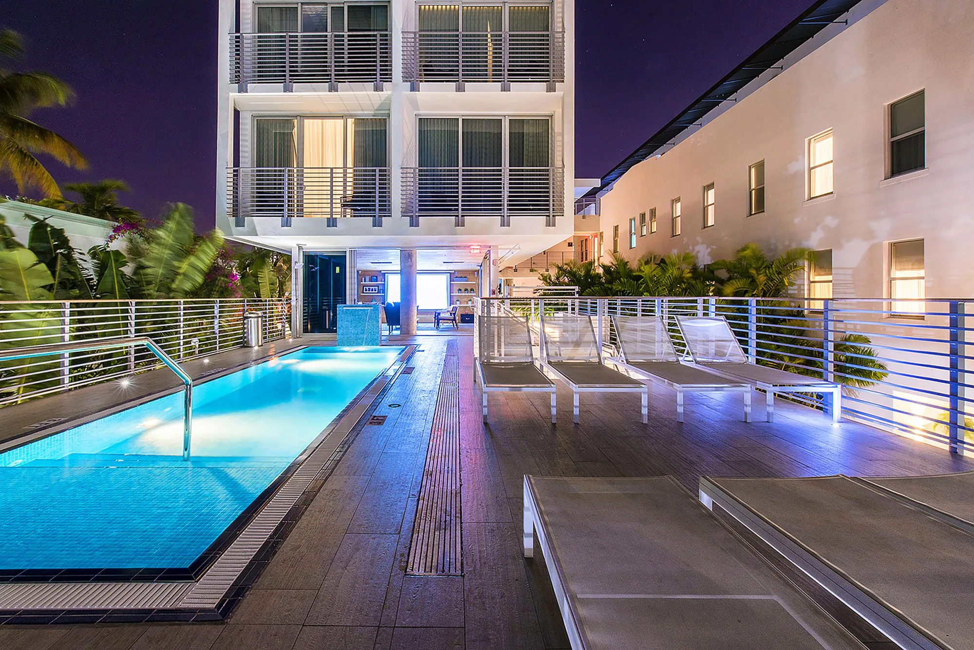 Pool deck at night with illuminated railings and louvers - The Meridian Hotel, Miami Beach FL