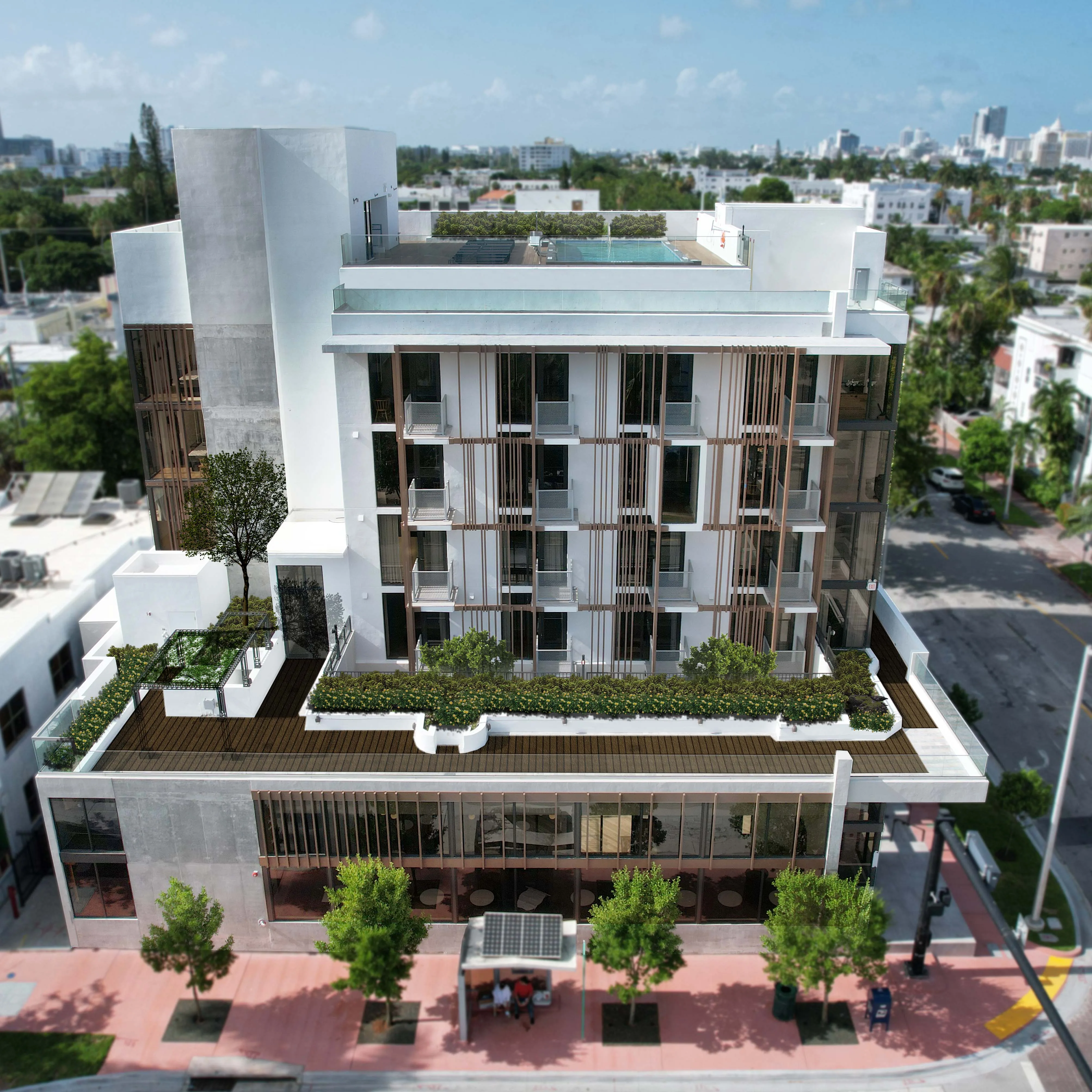 Aerial view of Upsun Hotel showing rooftop pool with glass railings, facade louver system, and terrace deck - Miami Beach FL