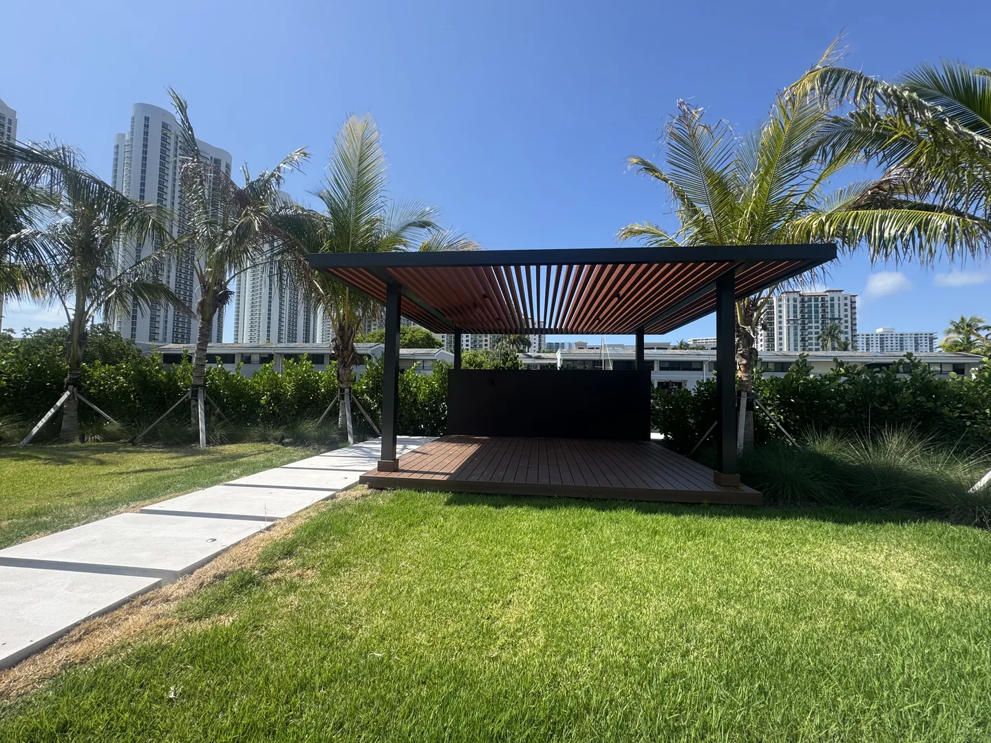 Pergola pavilion framed by palms - Atlantic Ave Residence gallery