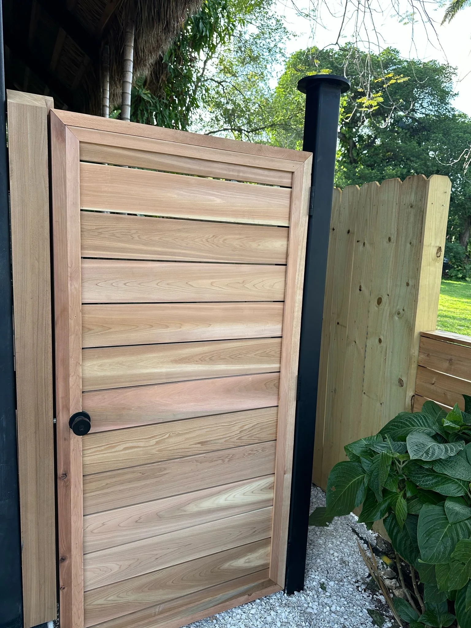 Custom cedar gate with lock hardware and tiki thatch - Jungle Book Residence, Miami FL