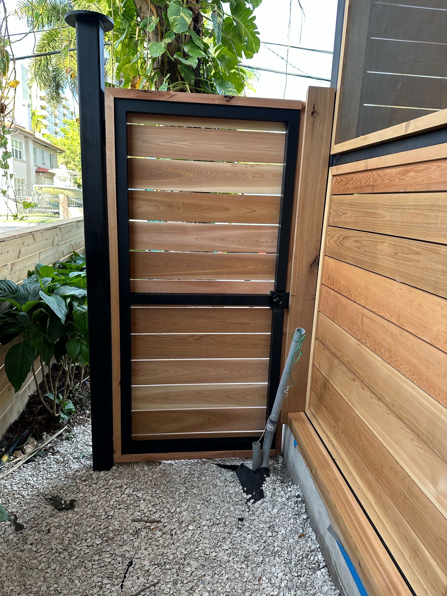 Cedar louver gate installation with aluminum post — Jungle Book Residence, Miami FL