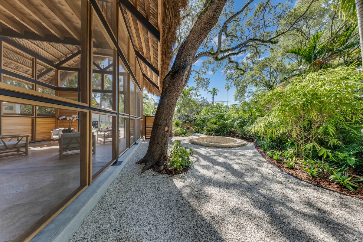 Steel frame carport structure with cedar wood panels and garden — Jungle Book Residence, Miami FL