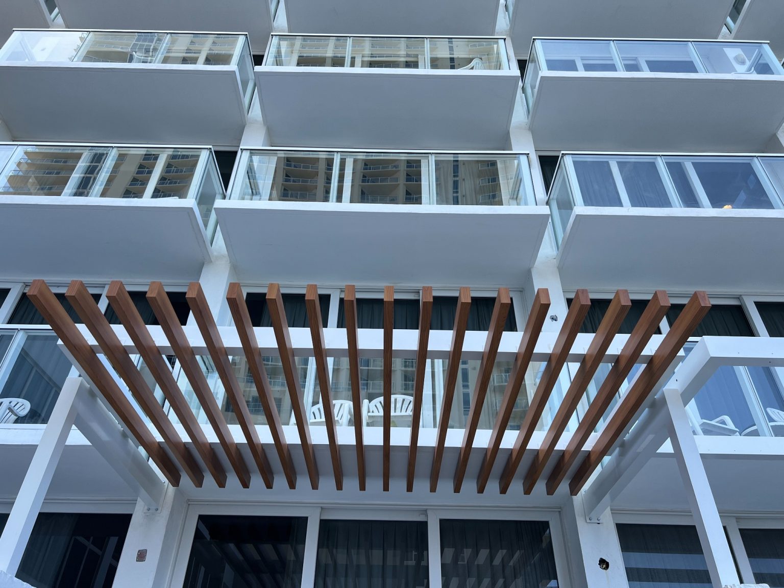 Wooden trellis installation on resort balcony facade